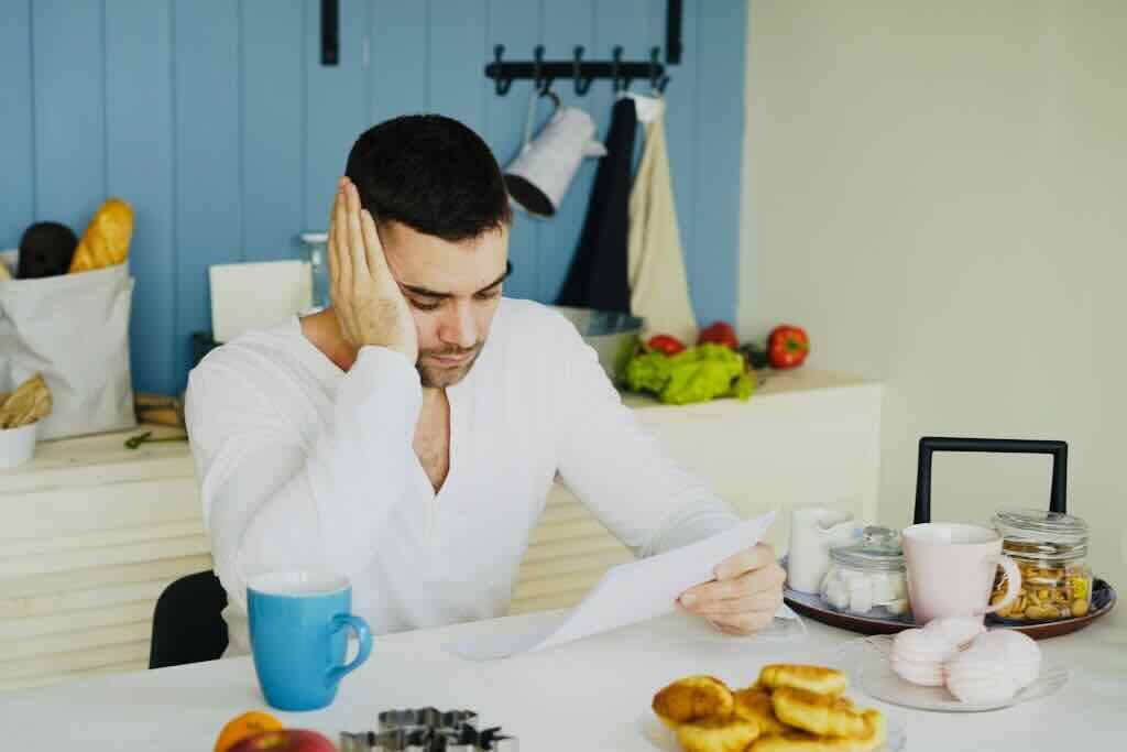 Man frustrated reading his GAPS protocol and surrounded by non-GAPS food because he thinks GAPS doesn't work.